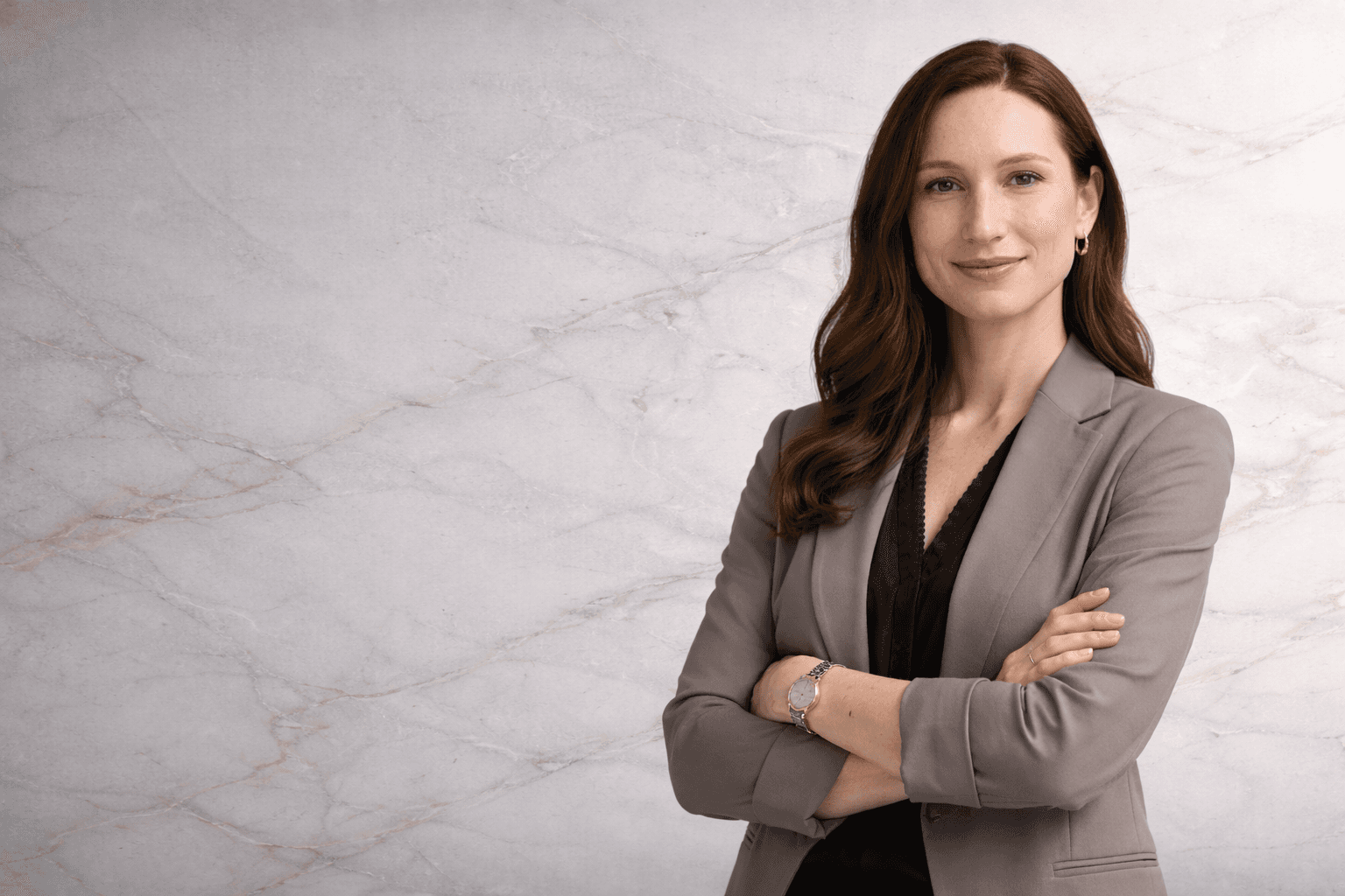 woman in blue tank top standing beside white wall