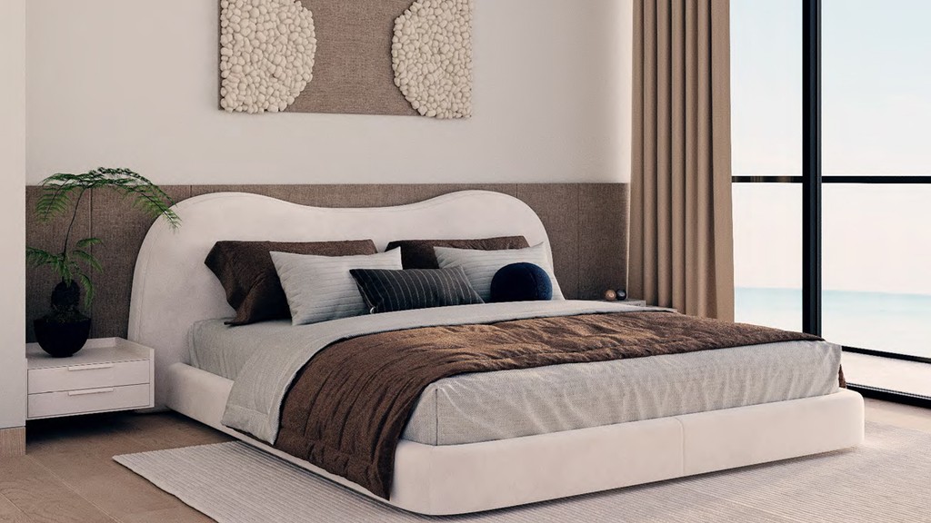 Modern bedroom at Edgewater Residences featuring a white bed adorned with brown pillows.
