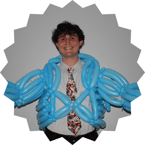 Daniel posing with a tie and blue muscle balloon suit