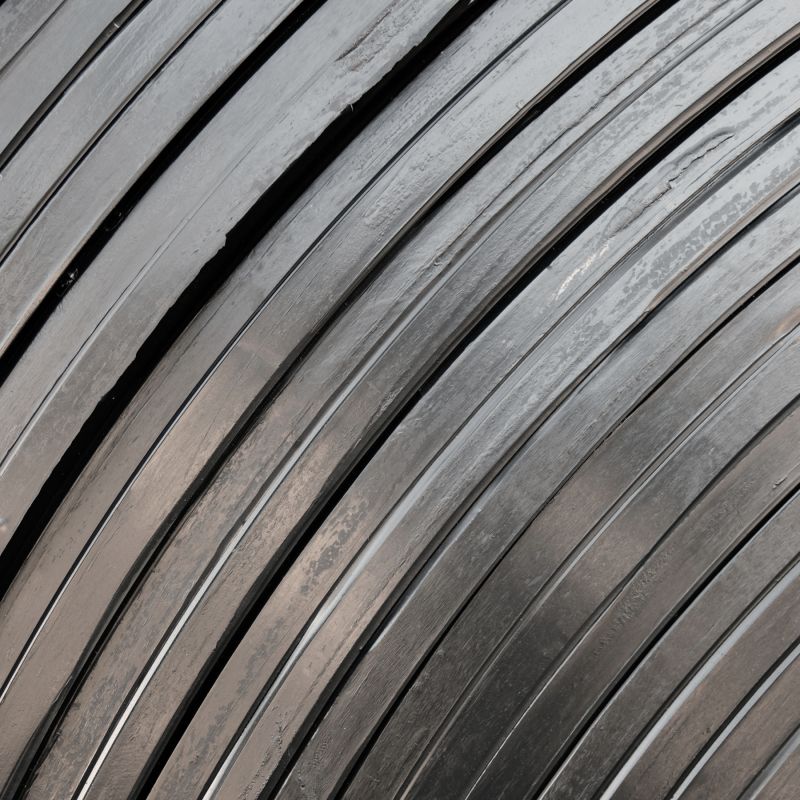 Close-up of a green palm leaf with intricate veining and texture, showcasing rich shades of green.