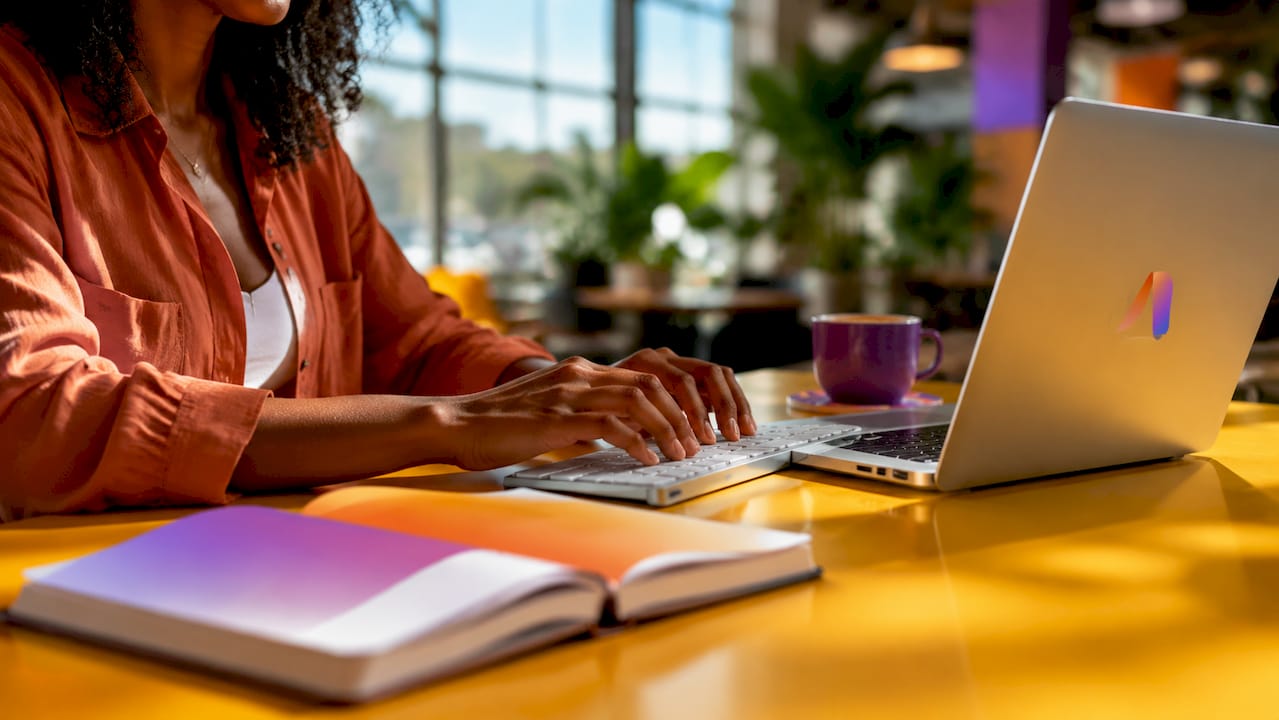 Hands typing on keyboard in home office