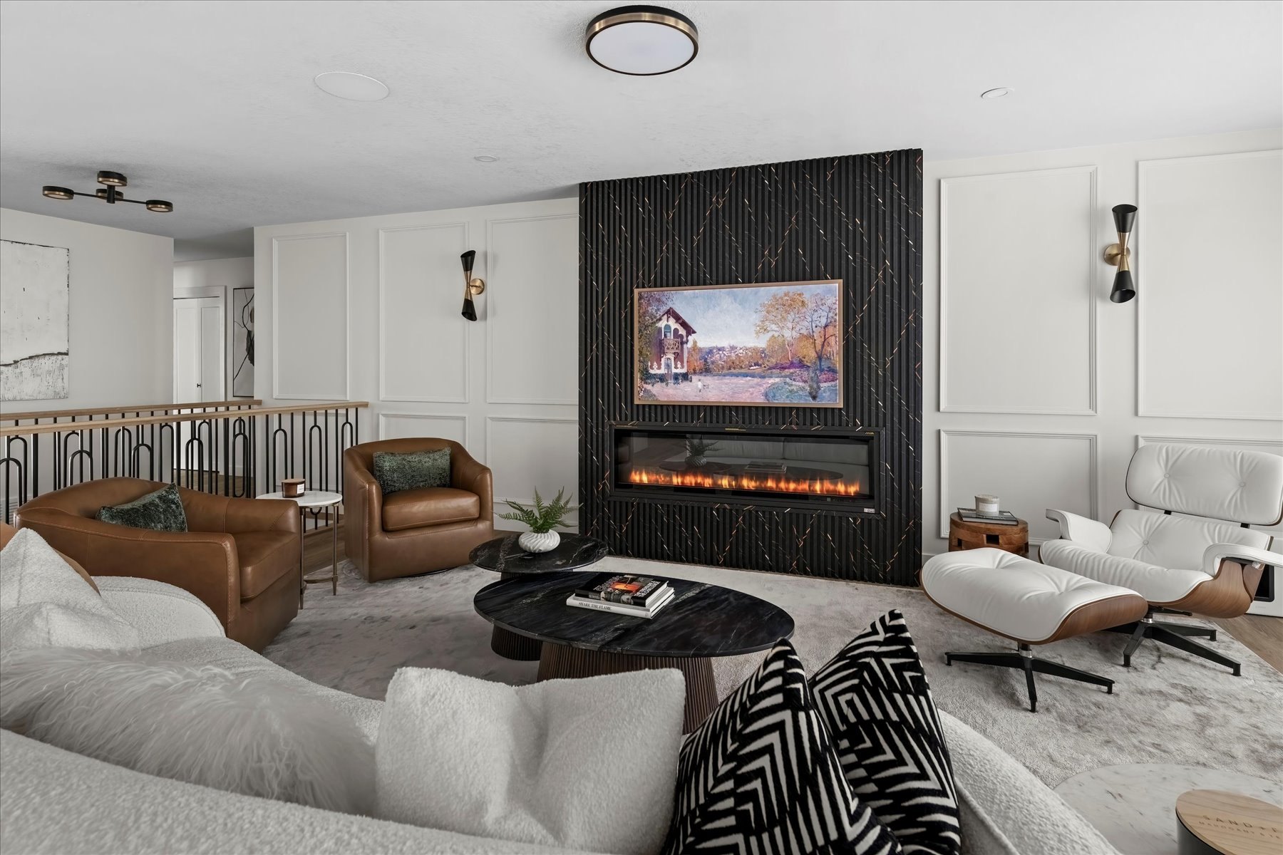 Strathcona living room after: black fireplace wall, panelled walls and layered seating