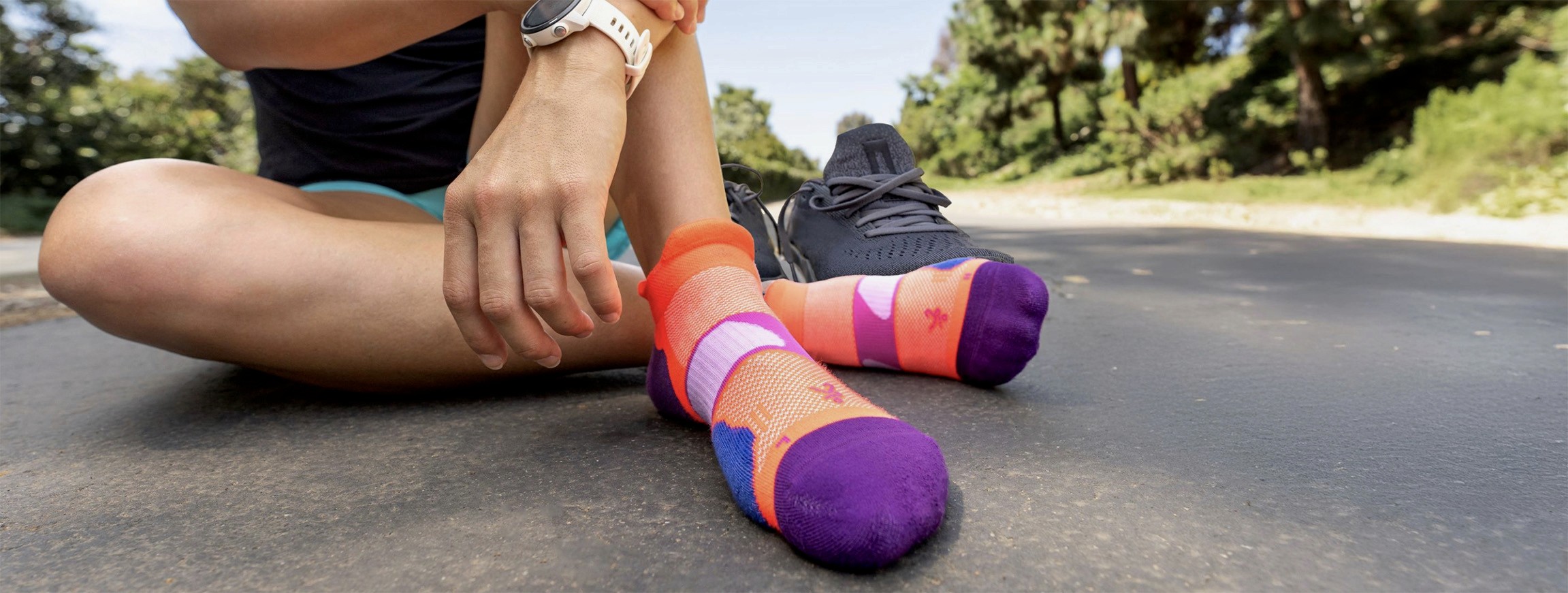 Close-up of a runner adjusting Balega athletic socks before a workout, reflecting preparation, precision, and active lifestyle.