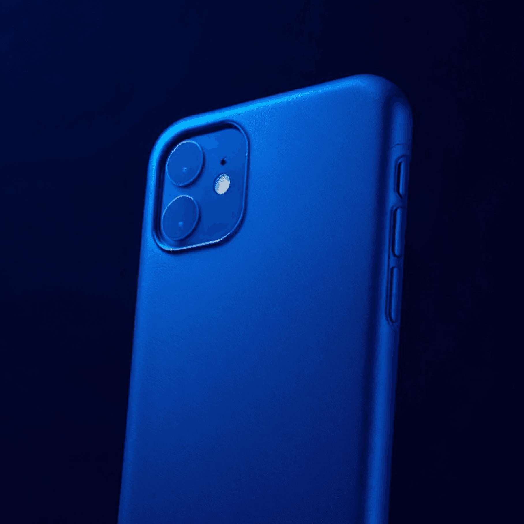 Rear view of a blue-cased iPhone with dual cameras on a dark blue background