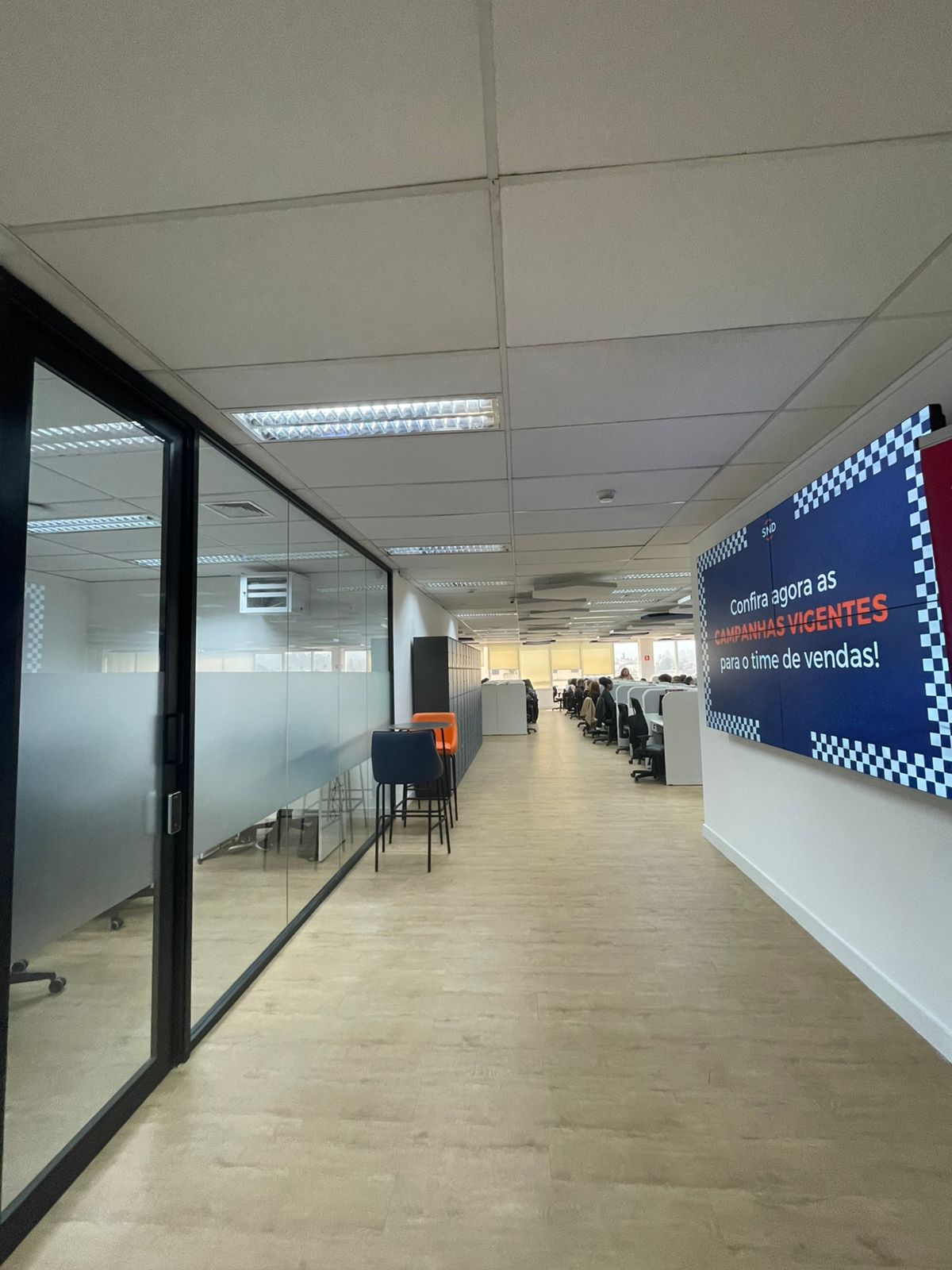 Beige interior with natural stone walls, sunlight, and geometric shadows over a calm water pool.