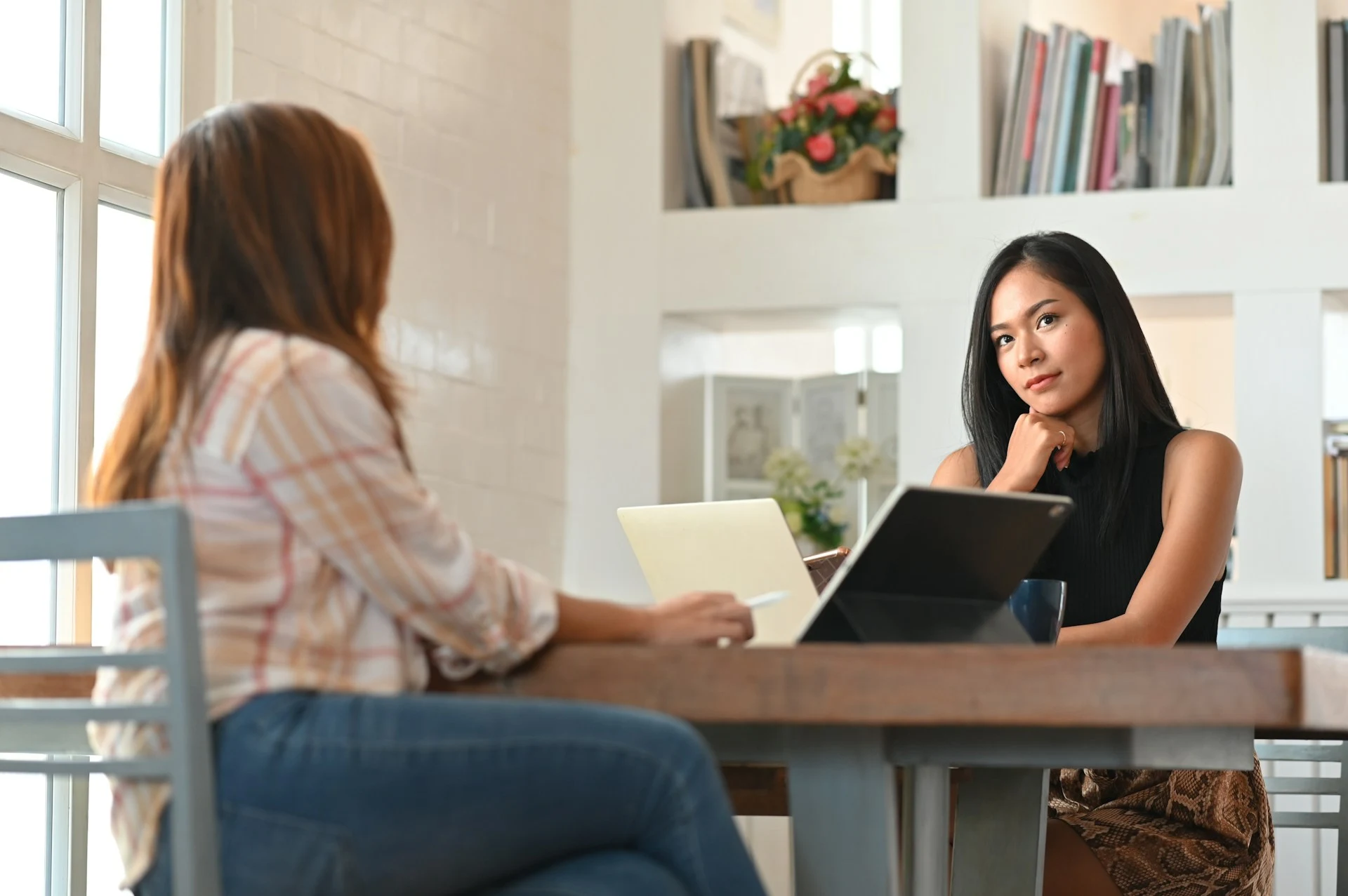 A woman listening to an expert explaining something.