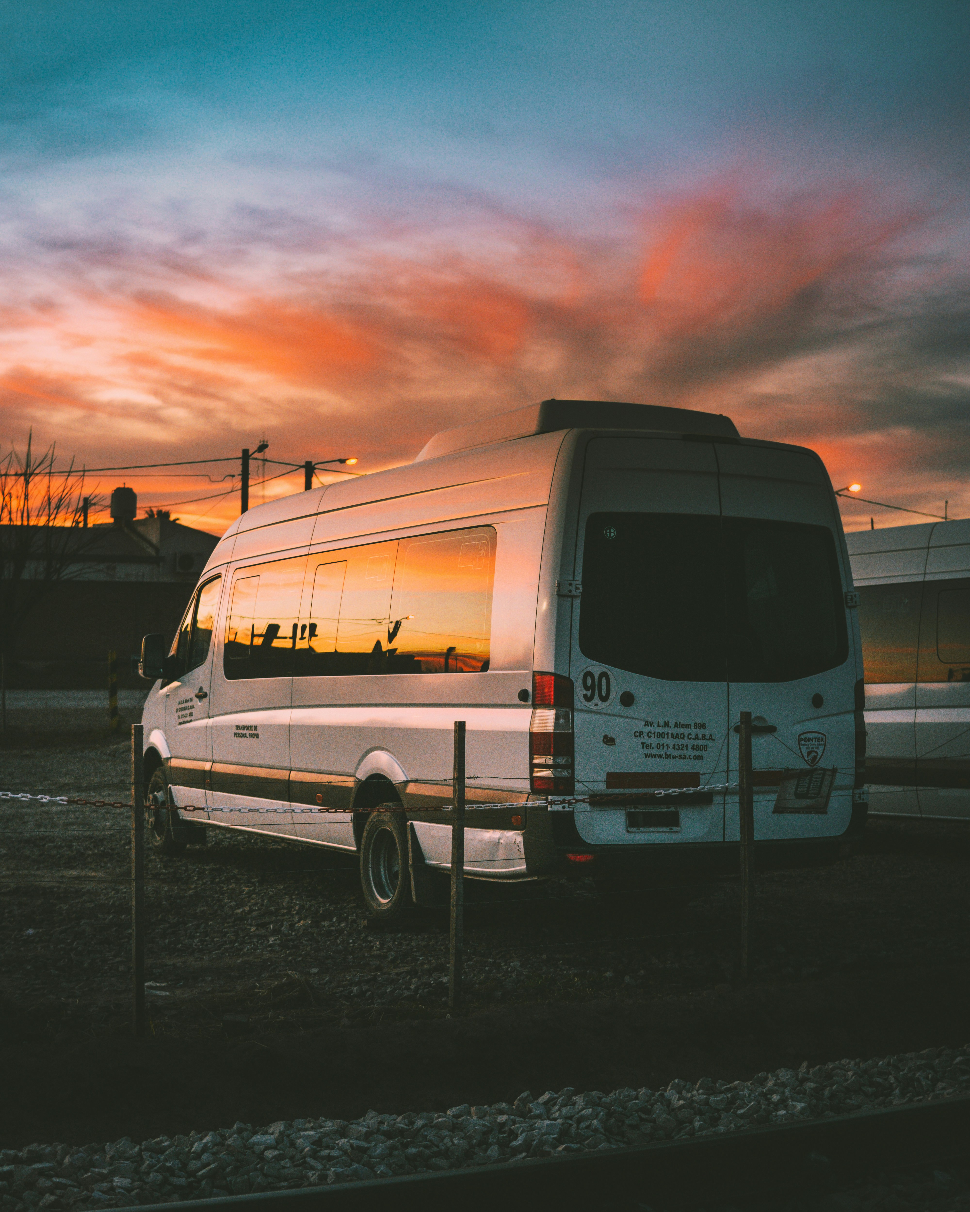 Mini bus overlooking a sunset sky.