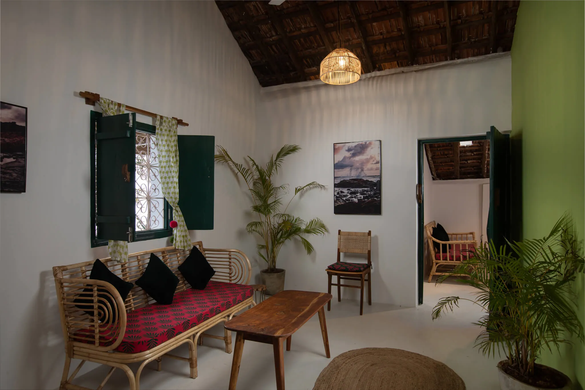 Cane-furnished sitting room in a Casa Jaali cottage