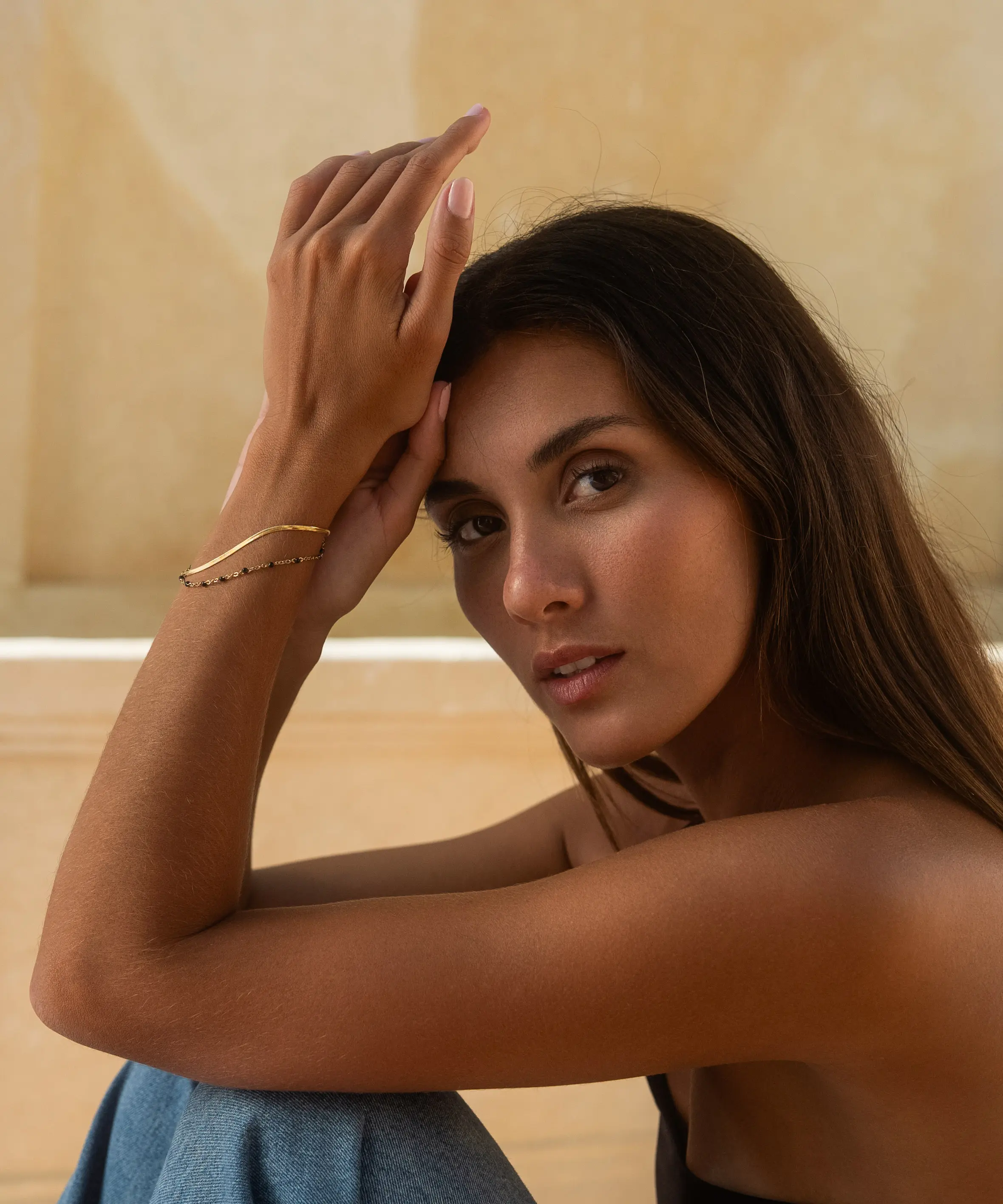 brunette model with golden bracelet outdoor villa