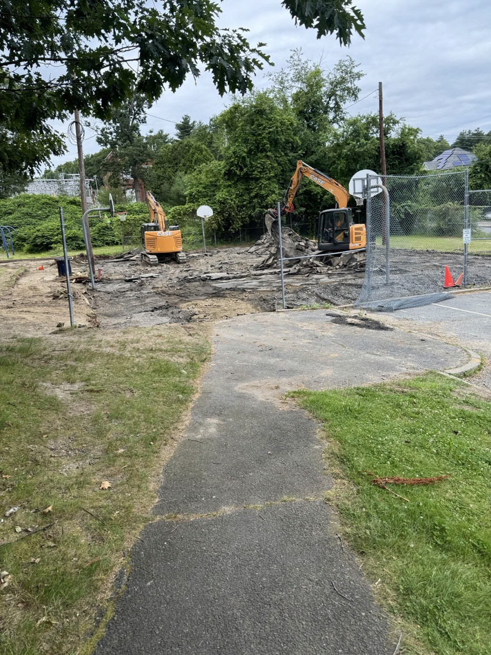Before: Excavators demolishing an old basketball court