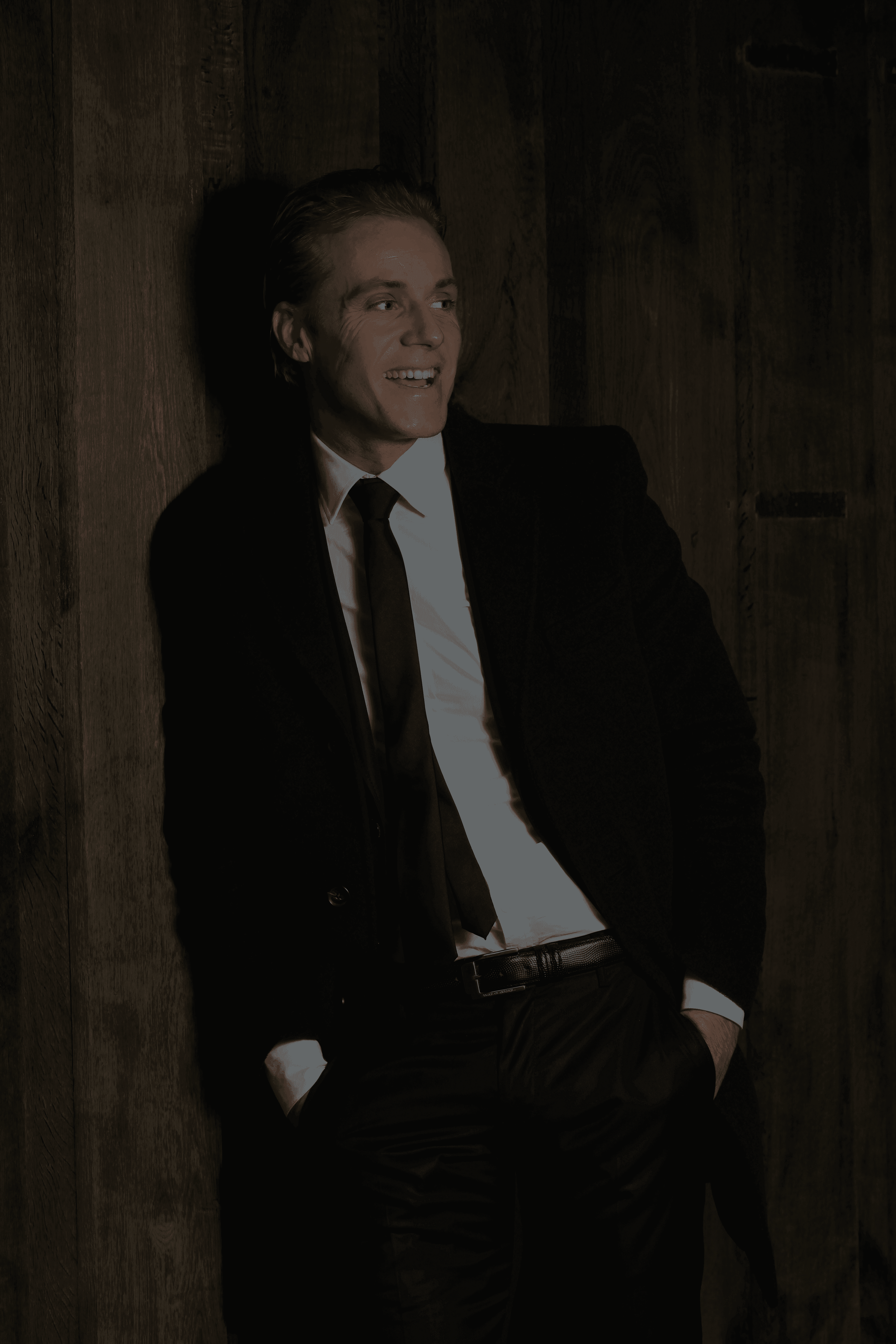 man standing beside wood