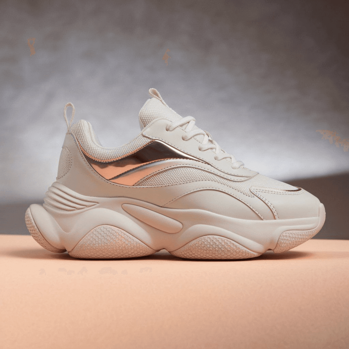 White Corbell Nova Edge women's sneaker with chunky sole and metallic rose gold accent.