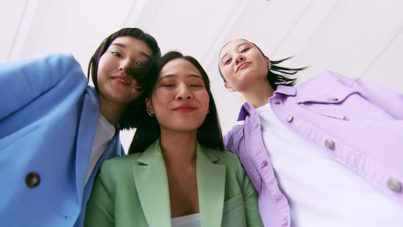 Three friends laughing into the lens