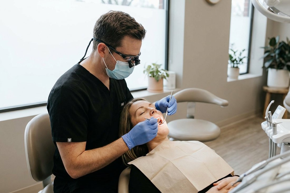 Dentist examining a patient's tooth to find the source of pain when biting down