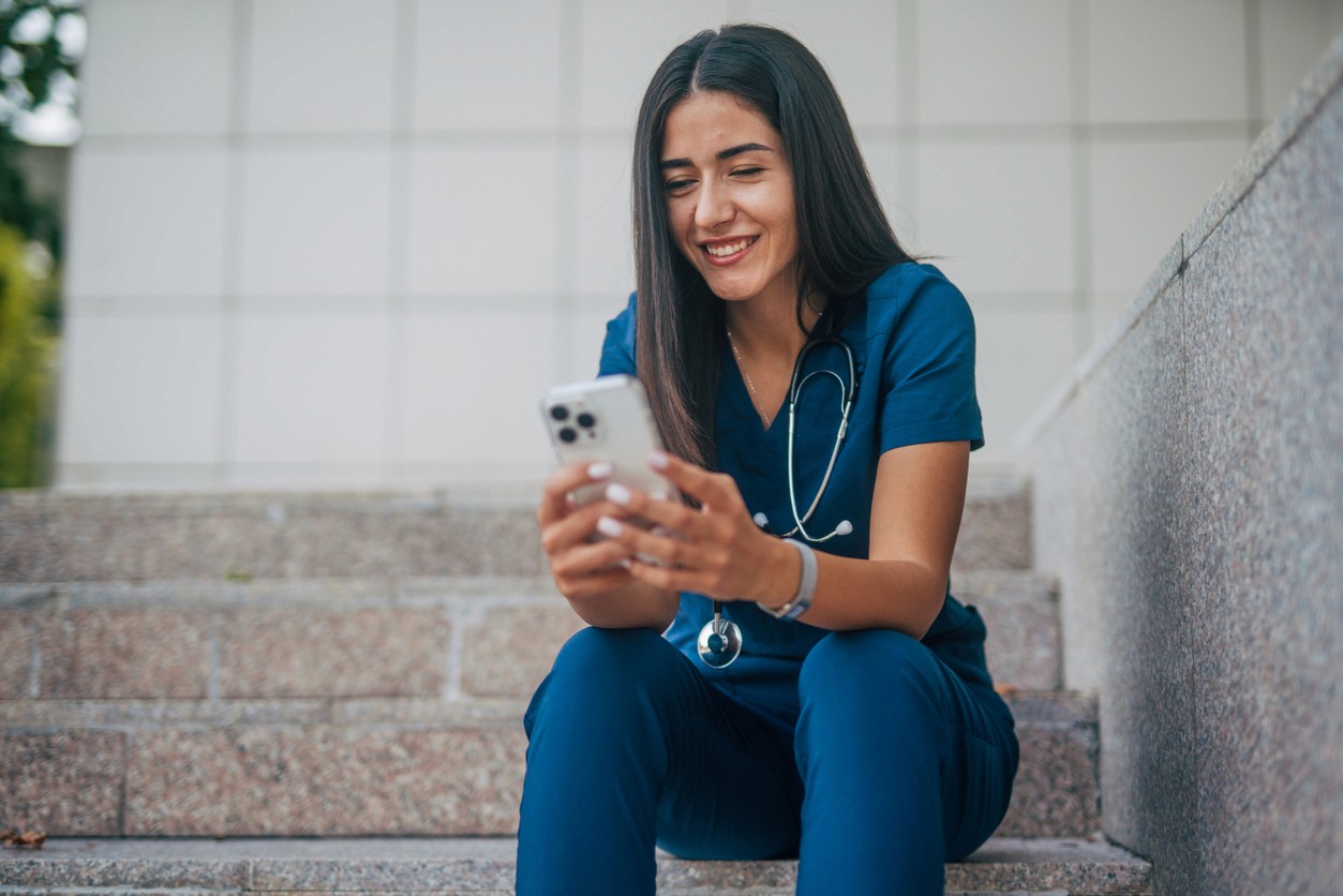 Stock image of nurse holding mobile phone