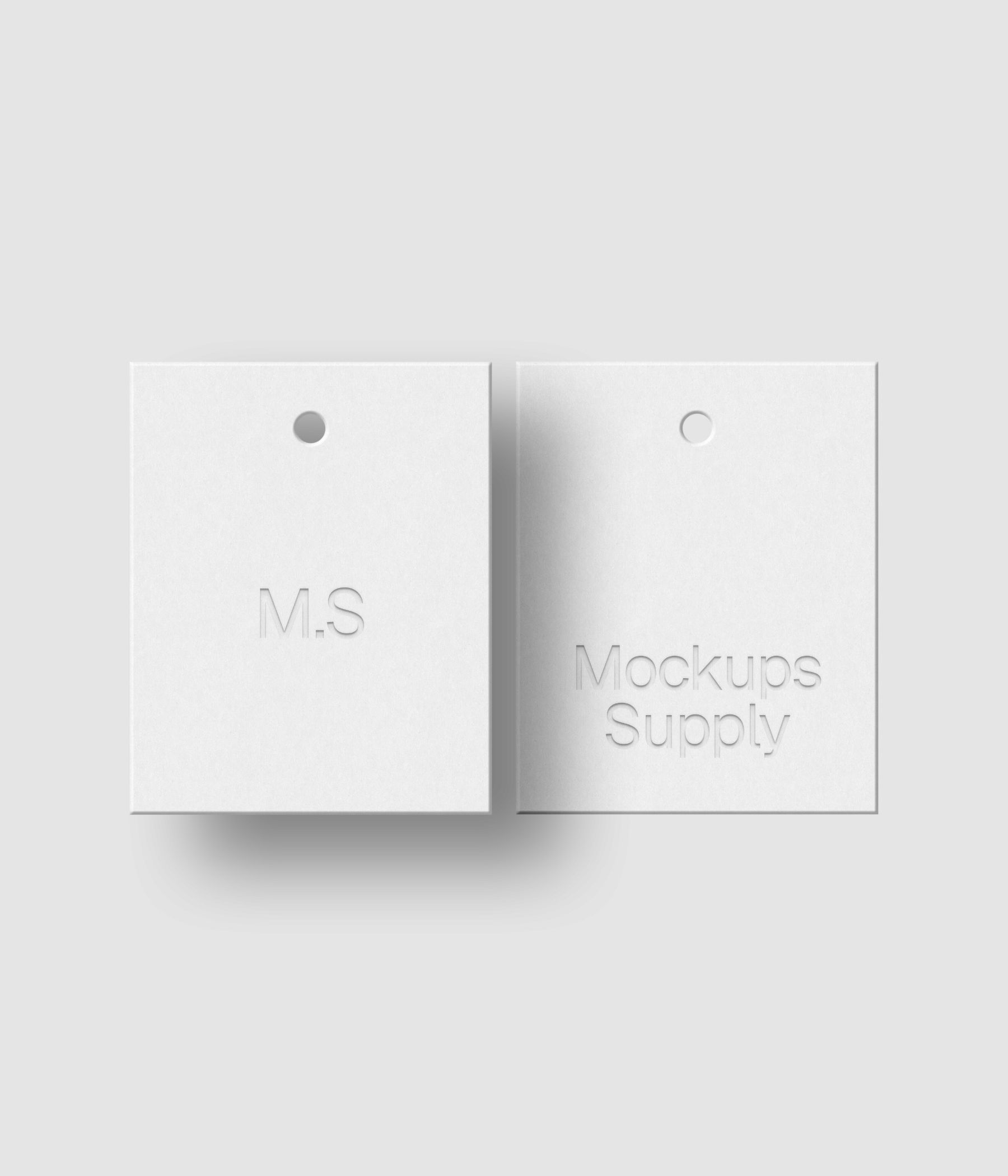Two white 4x5 clothing hang tags mockup on white background with soft shadow and debossed logo effect for Photoshop download psd