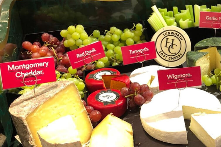 Cheese and grape display with labeled varieties