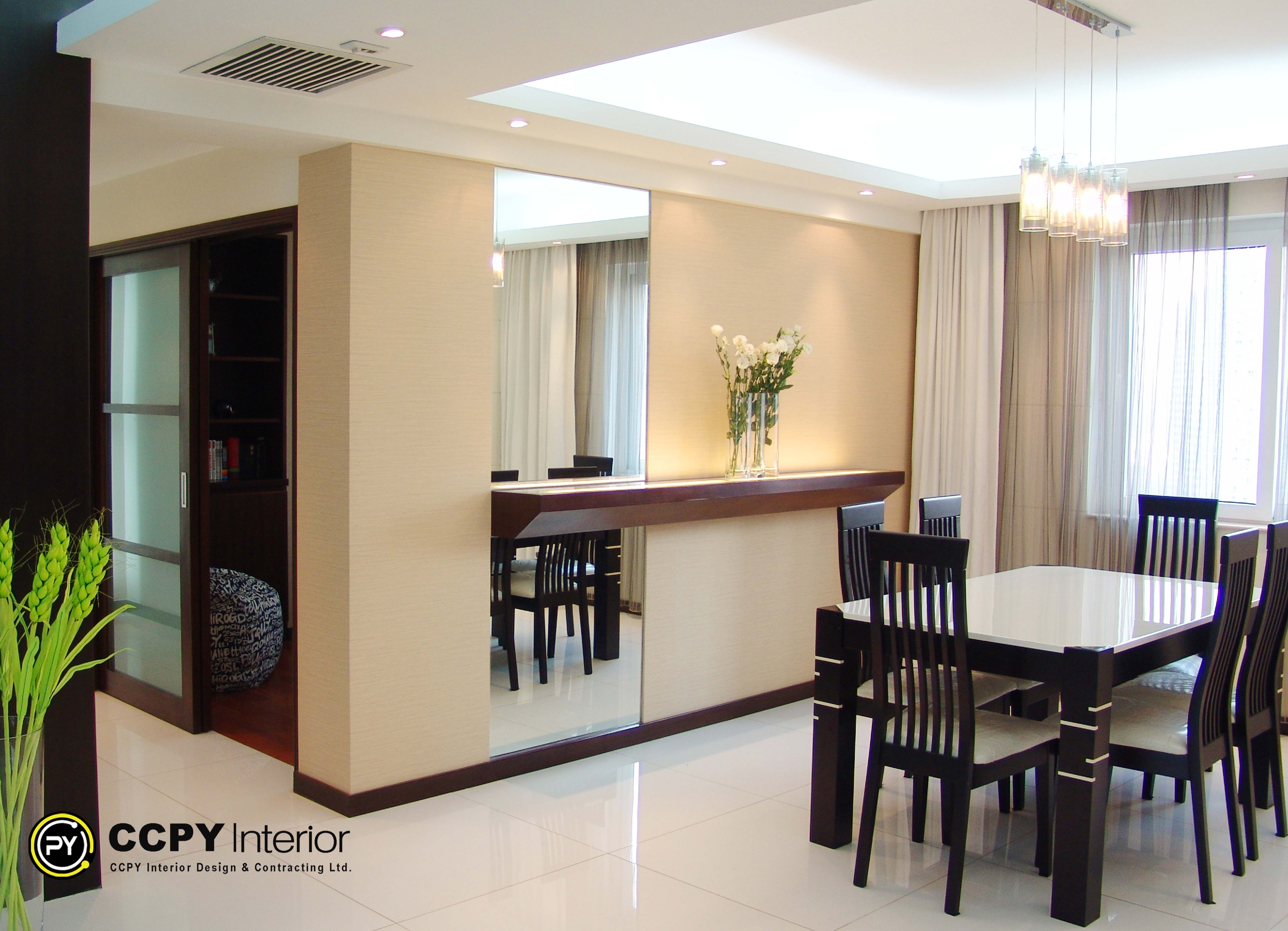 Modern entry foyer at Mount Pavilia 20 highlighting high-gloss paneled walls, sleek elevator access, and a distinctive monochrome geometric floor pattern.