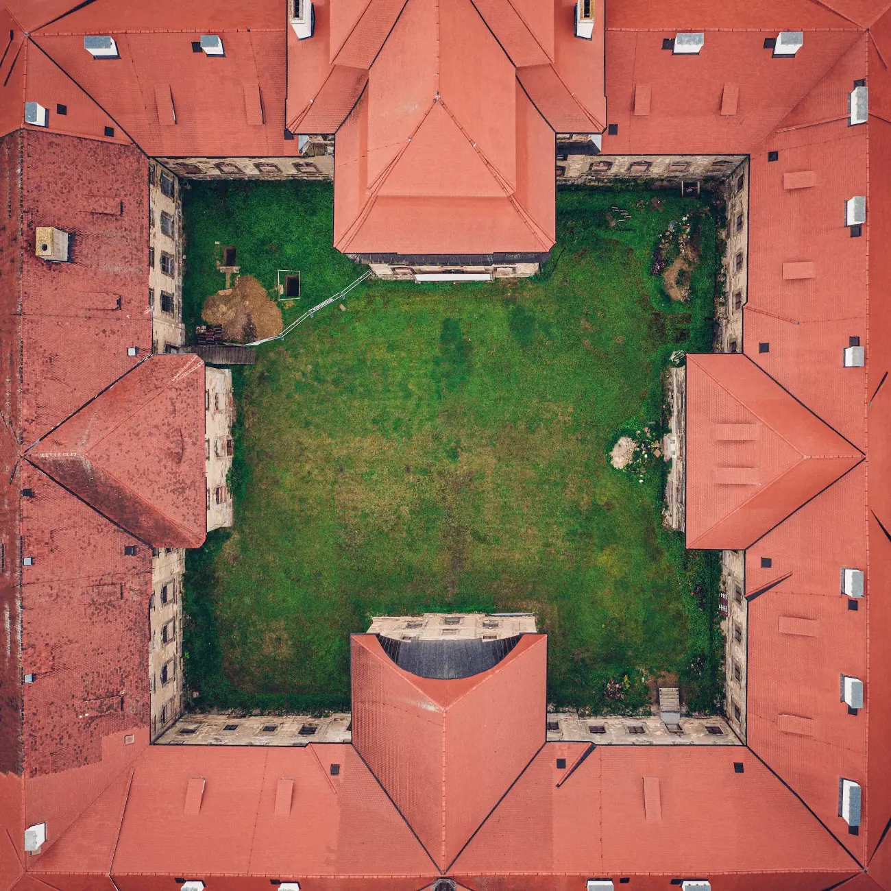 High-resolution overhead image of a historic building's tiled roof and courtyard from drone photography