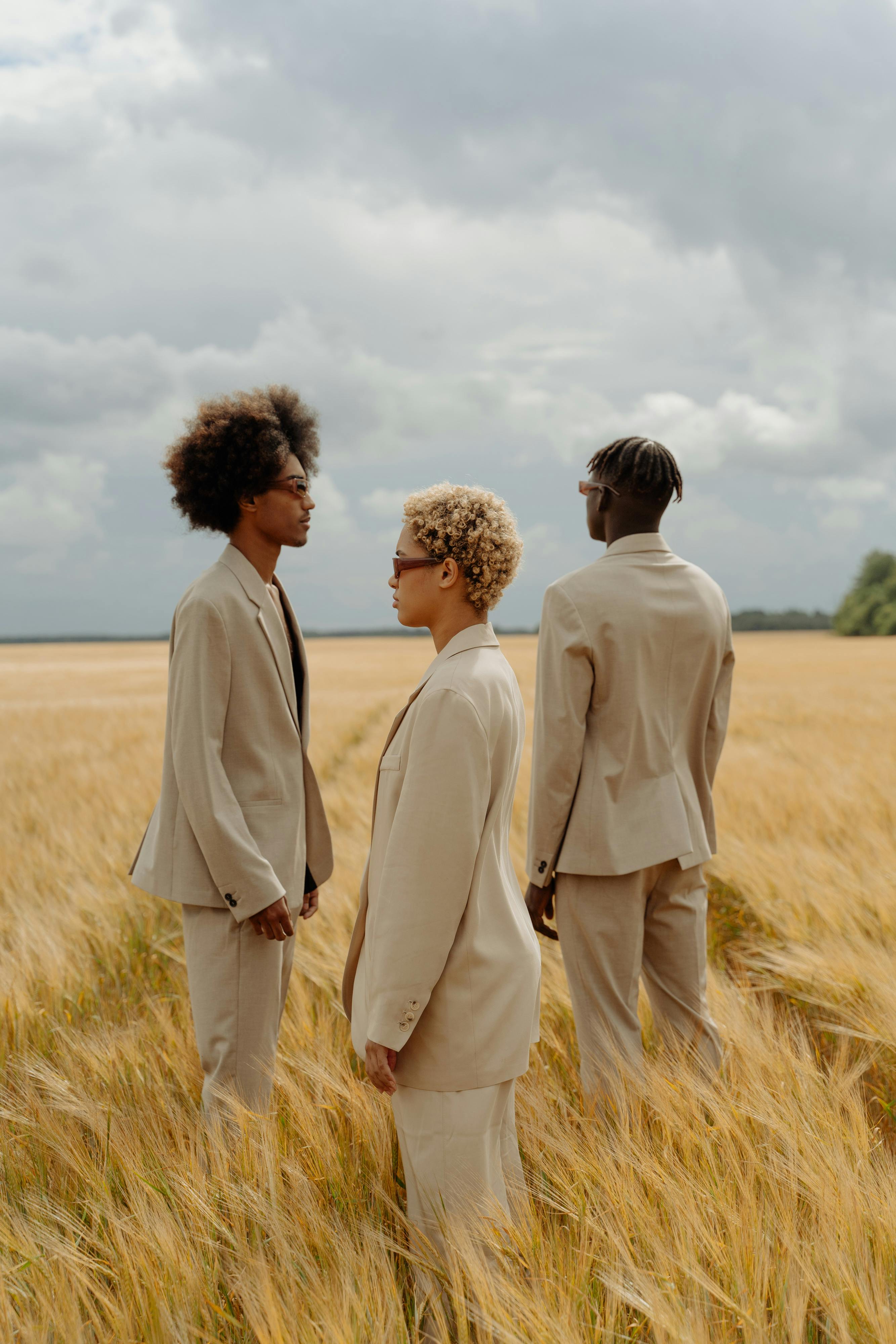 Three people standing in a field