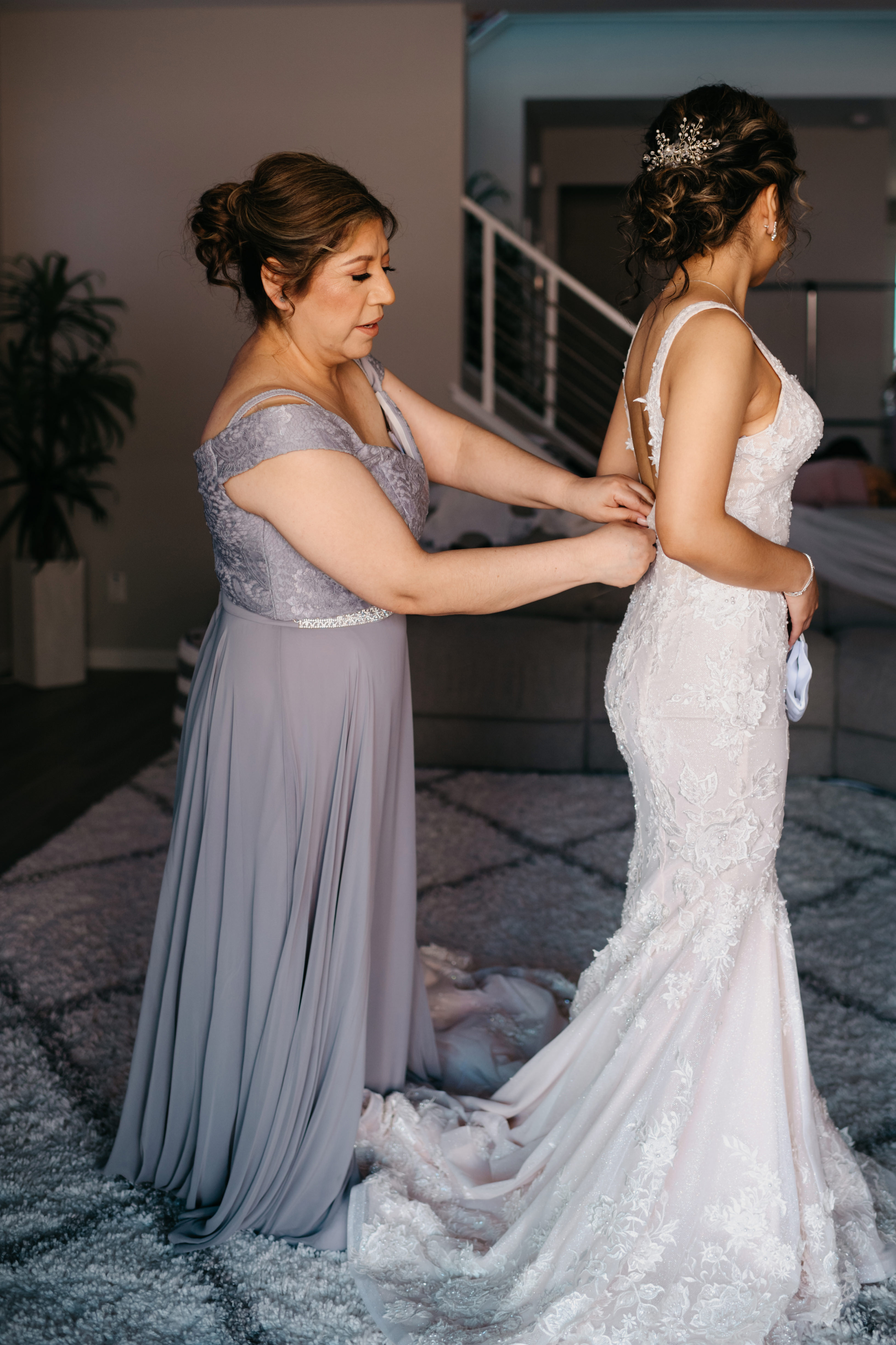 Bride getting into her wedding dress with the help of her mom in Las Vegas