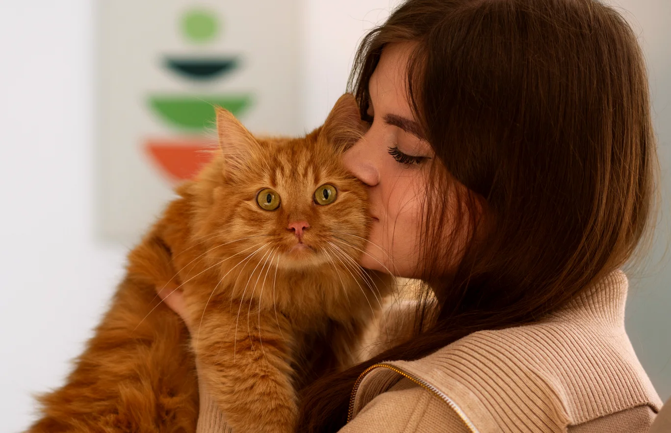 Woman holding orange cat