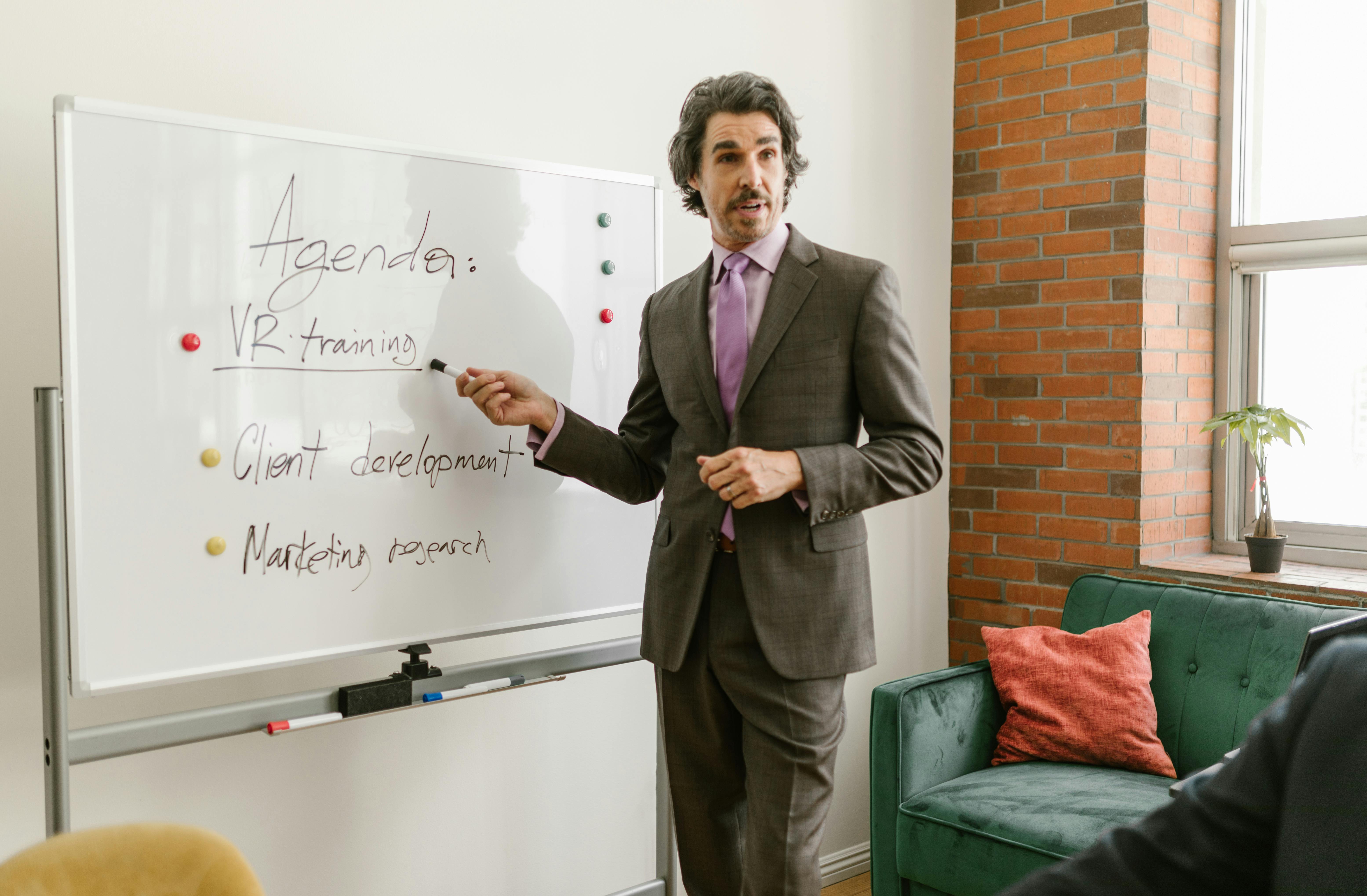 man-pointing-at-vr-training-in-whiteboard