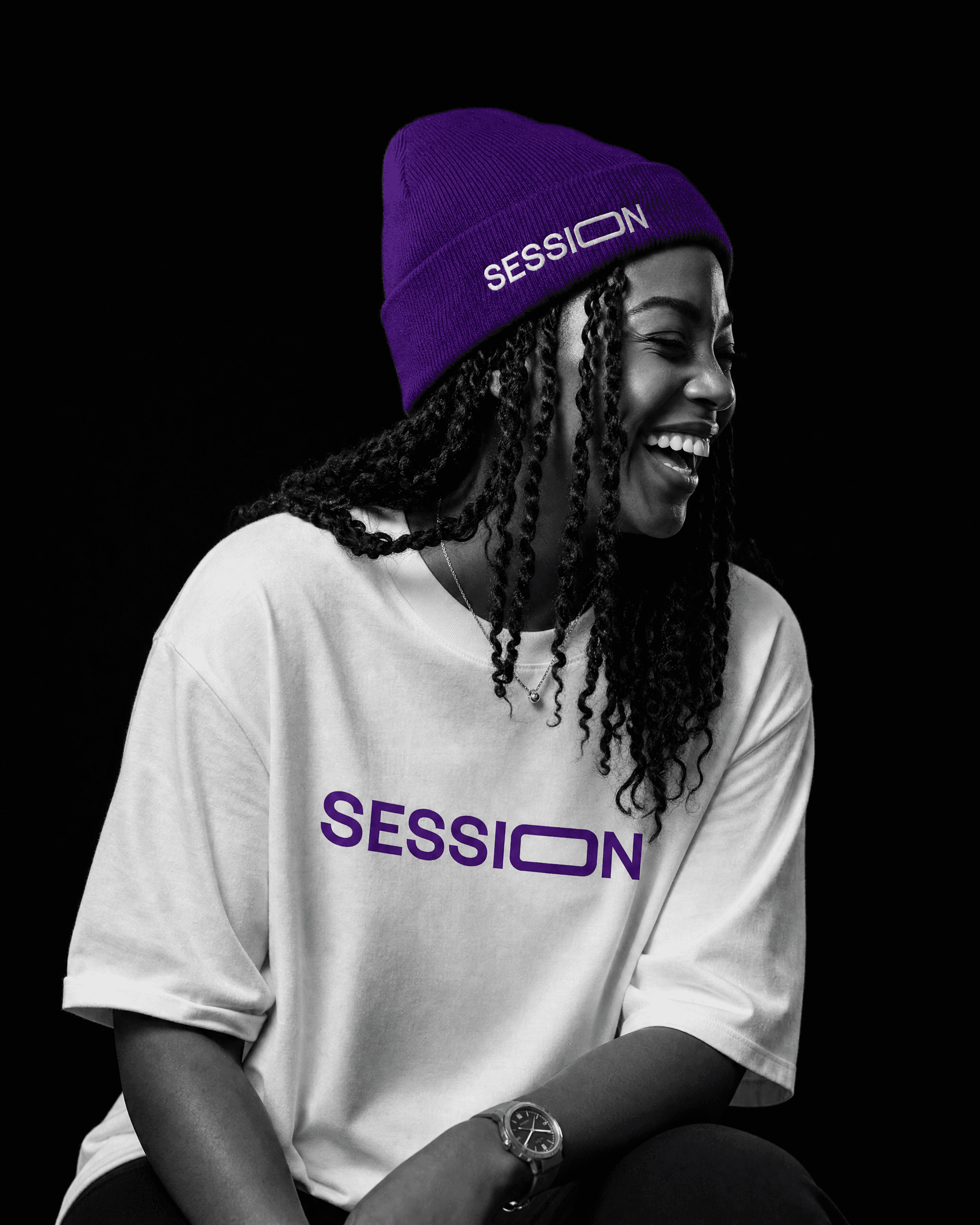 Woman laughing in a purple Session Zone beanie and white T-shirt with purple SESSION lettering.