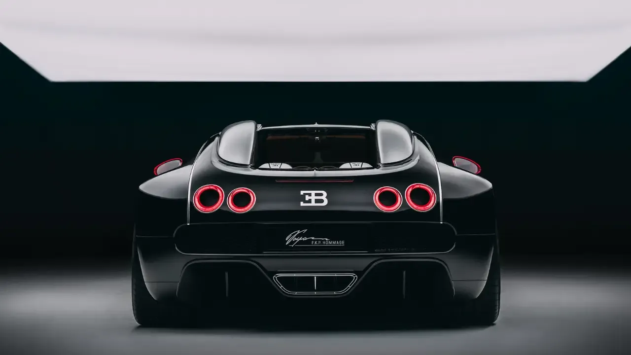 Rear view of a black hypercar in a studio setting