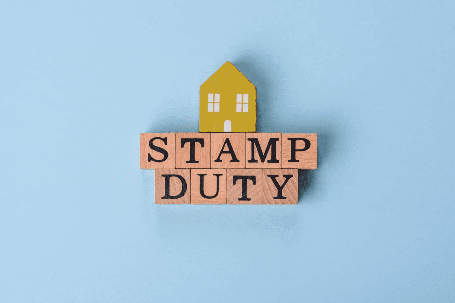 Stamp duty on wooden blocks with a house.