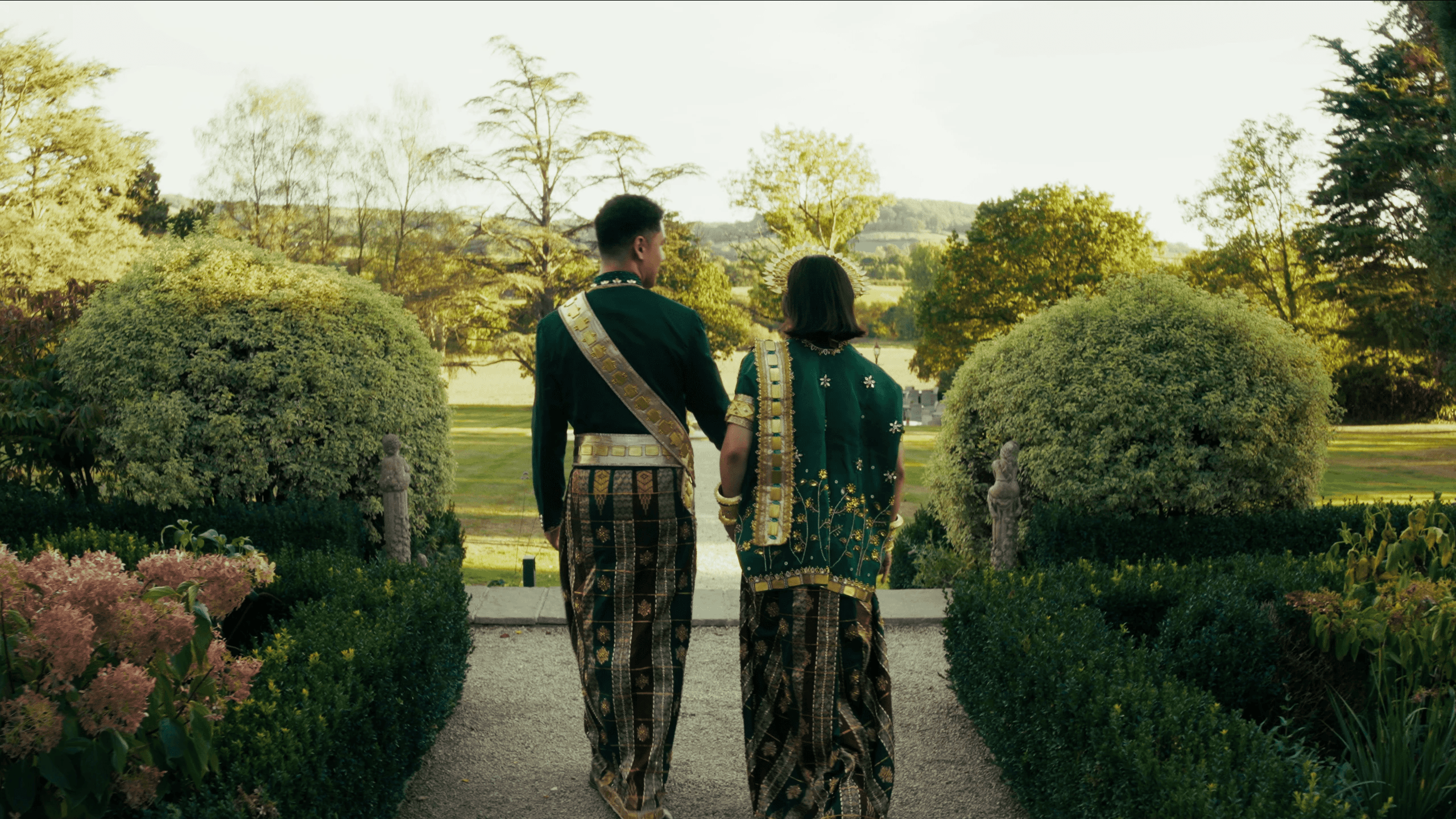 Married couple walking in garden
