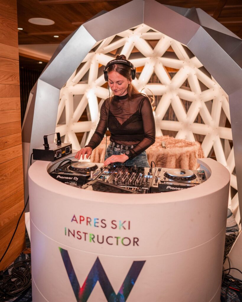 DJ performing at a crowded indoor event