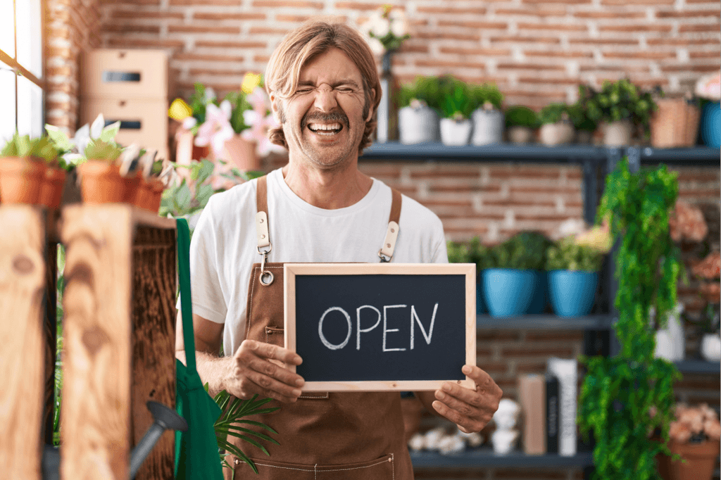 The flower shop owner smiling