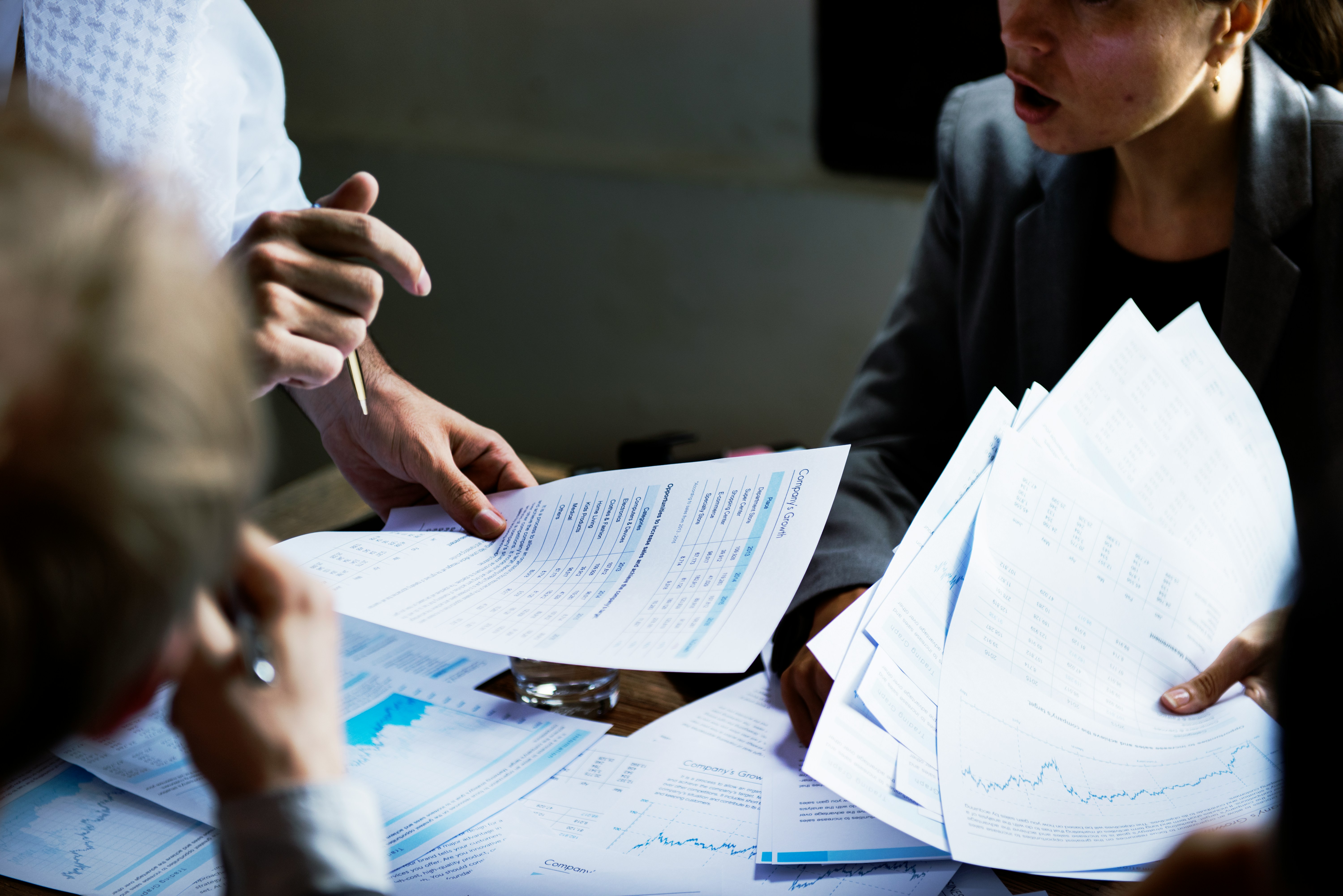 Cropped image of colleagues sharing company growth facts and figures