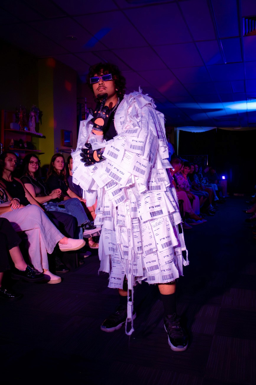 male model on runway wearing fabric that reads "F YOU"