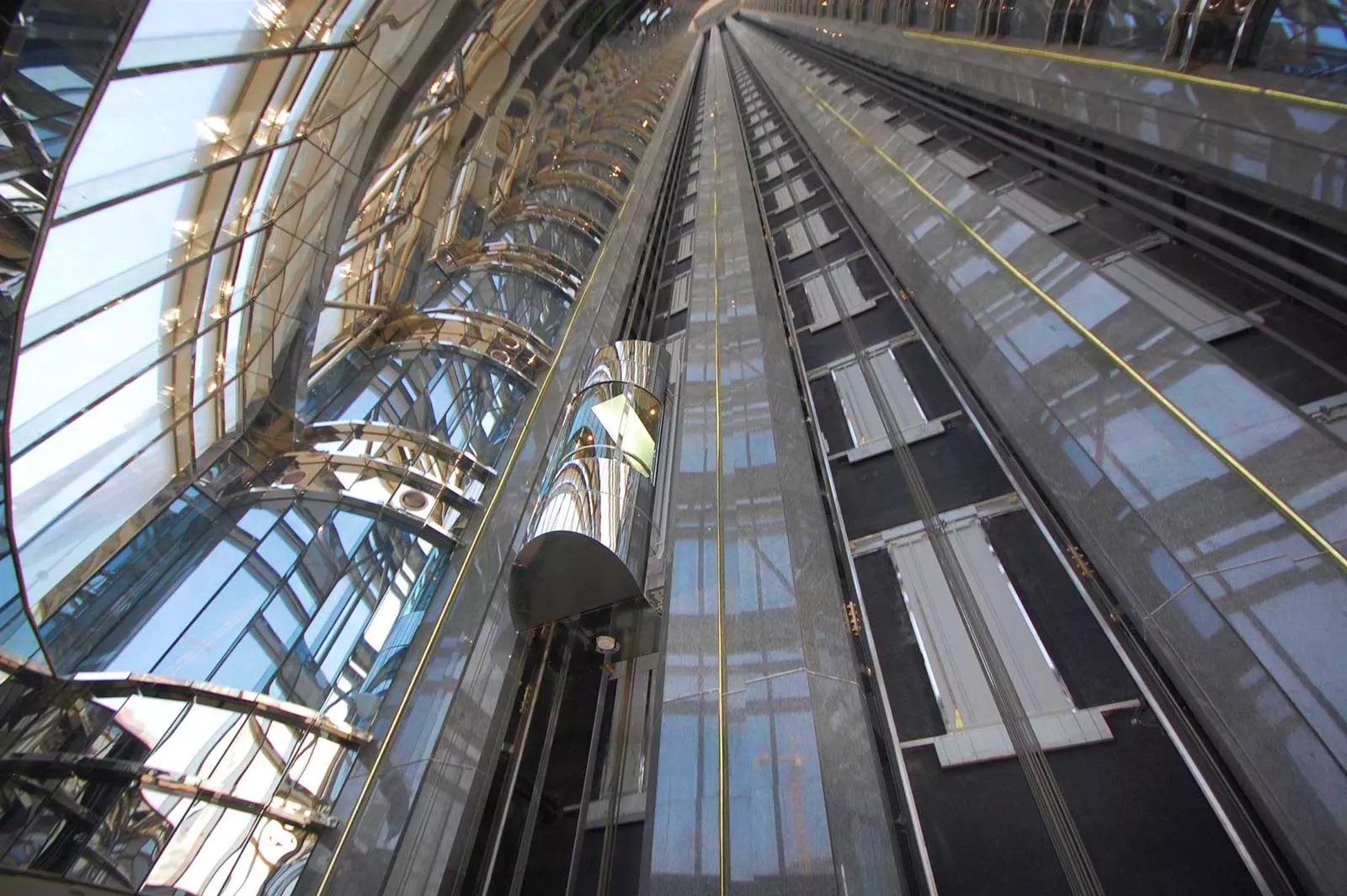 High-speed glass elevators in a luxury commercial tower managed by expert real estate agents.