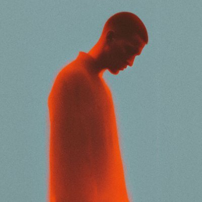 Portrait of Ronan in an Orange shirt