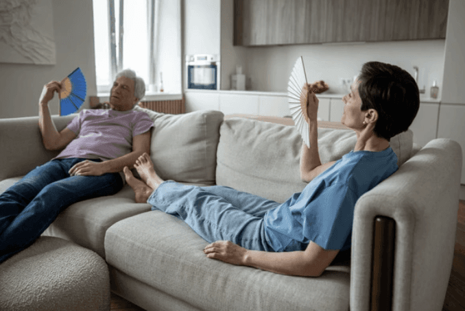 A family sits on their couch, dealing with the heat before calling the best insulation company in Granbury, Texas.