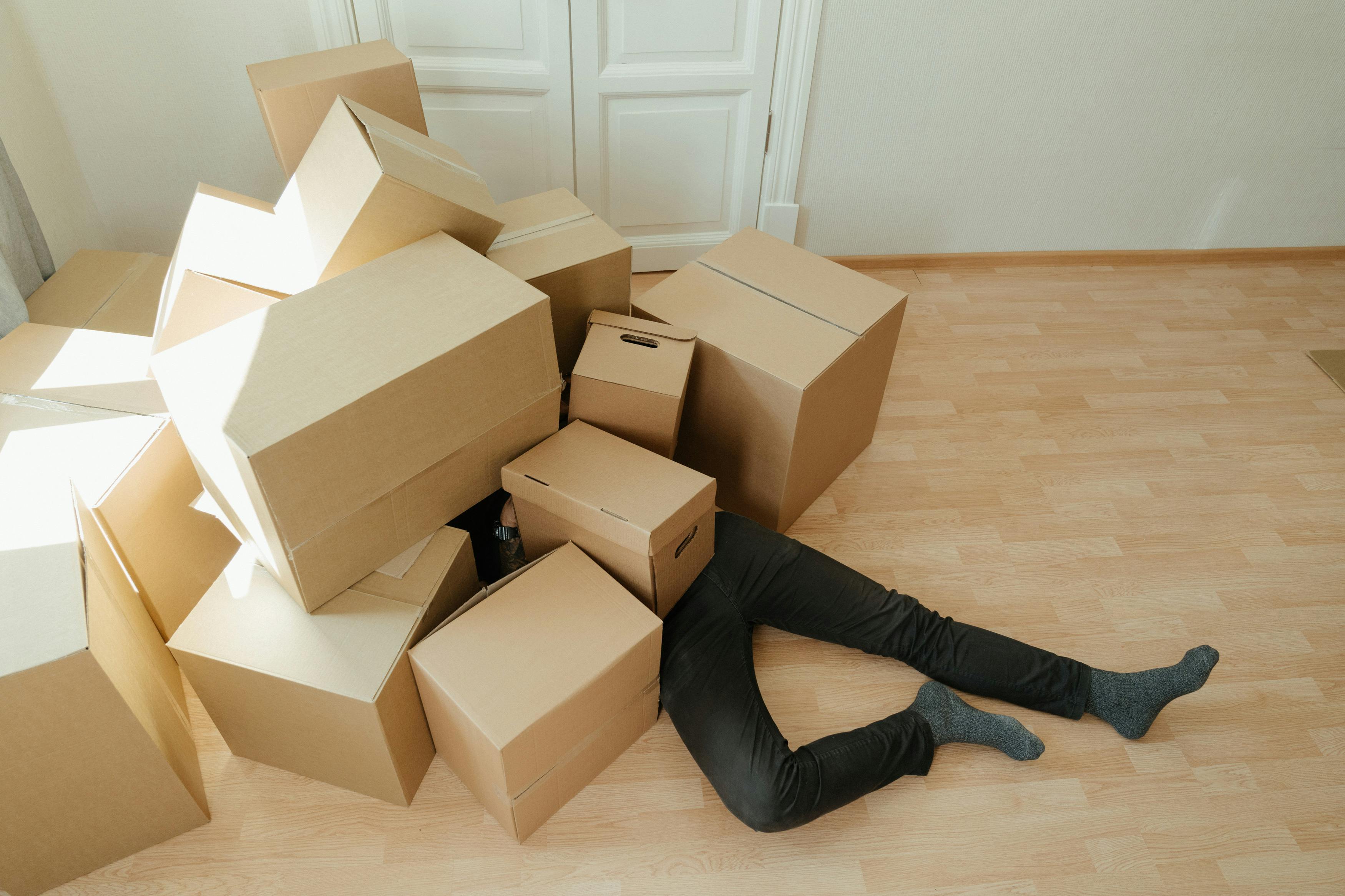 A person under a lot of boxes, representing clutter pages.