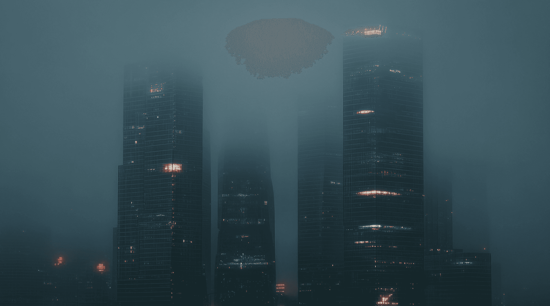 Skyscrapers shrouded in fog at night, with illuminated windows and red lights.