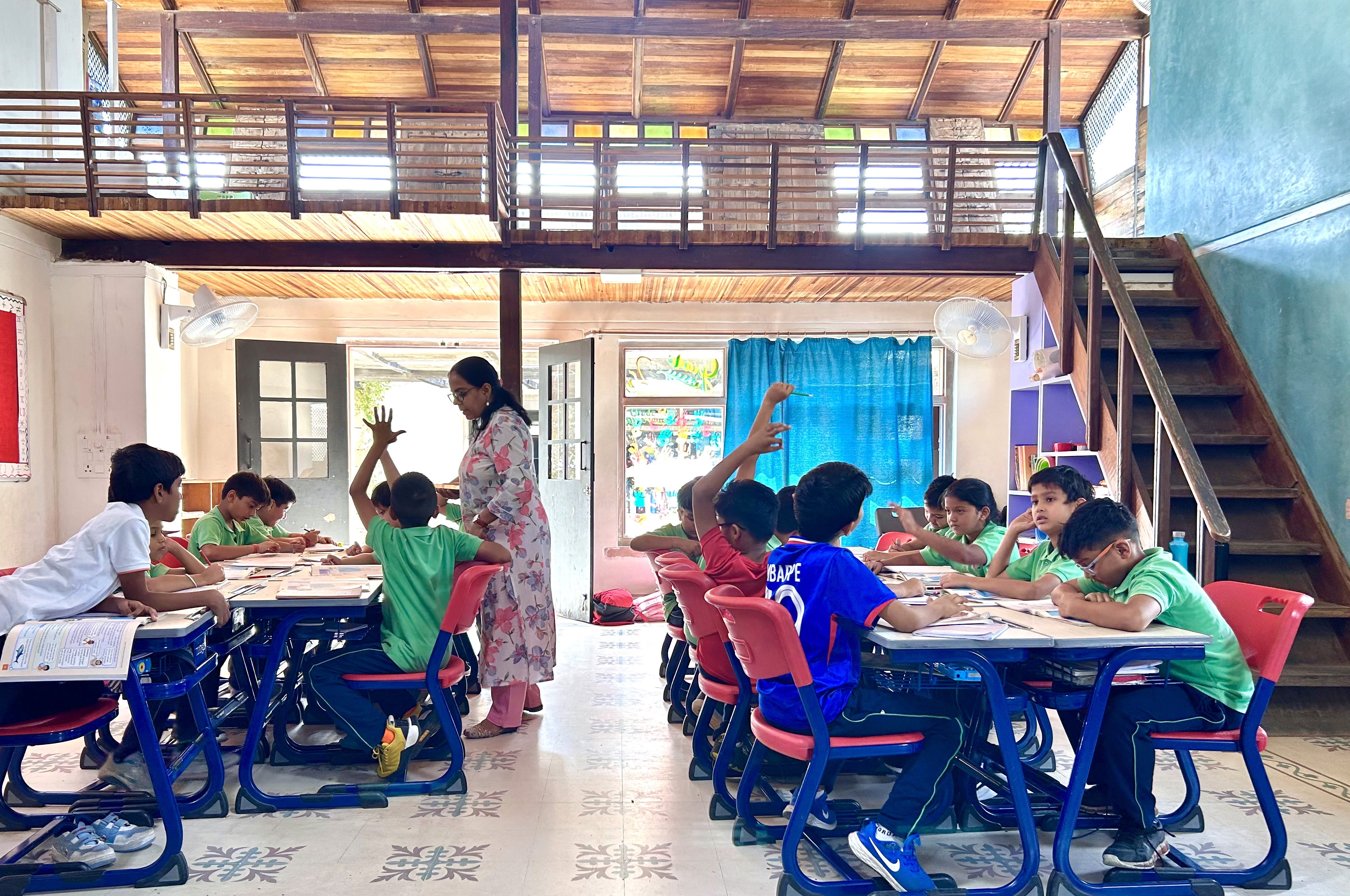 A schoolgirl participates in an online lesson using a tablet