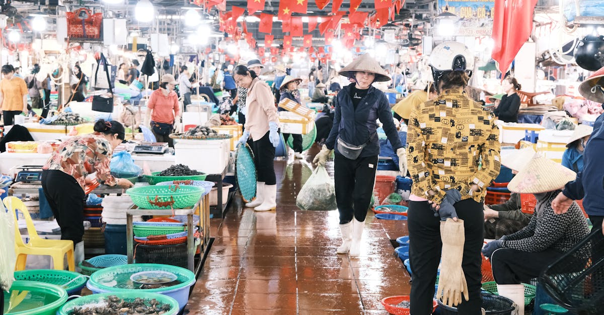 Vibrant indoor market bustling with vendors selling fresh produce in Vietnam.