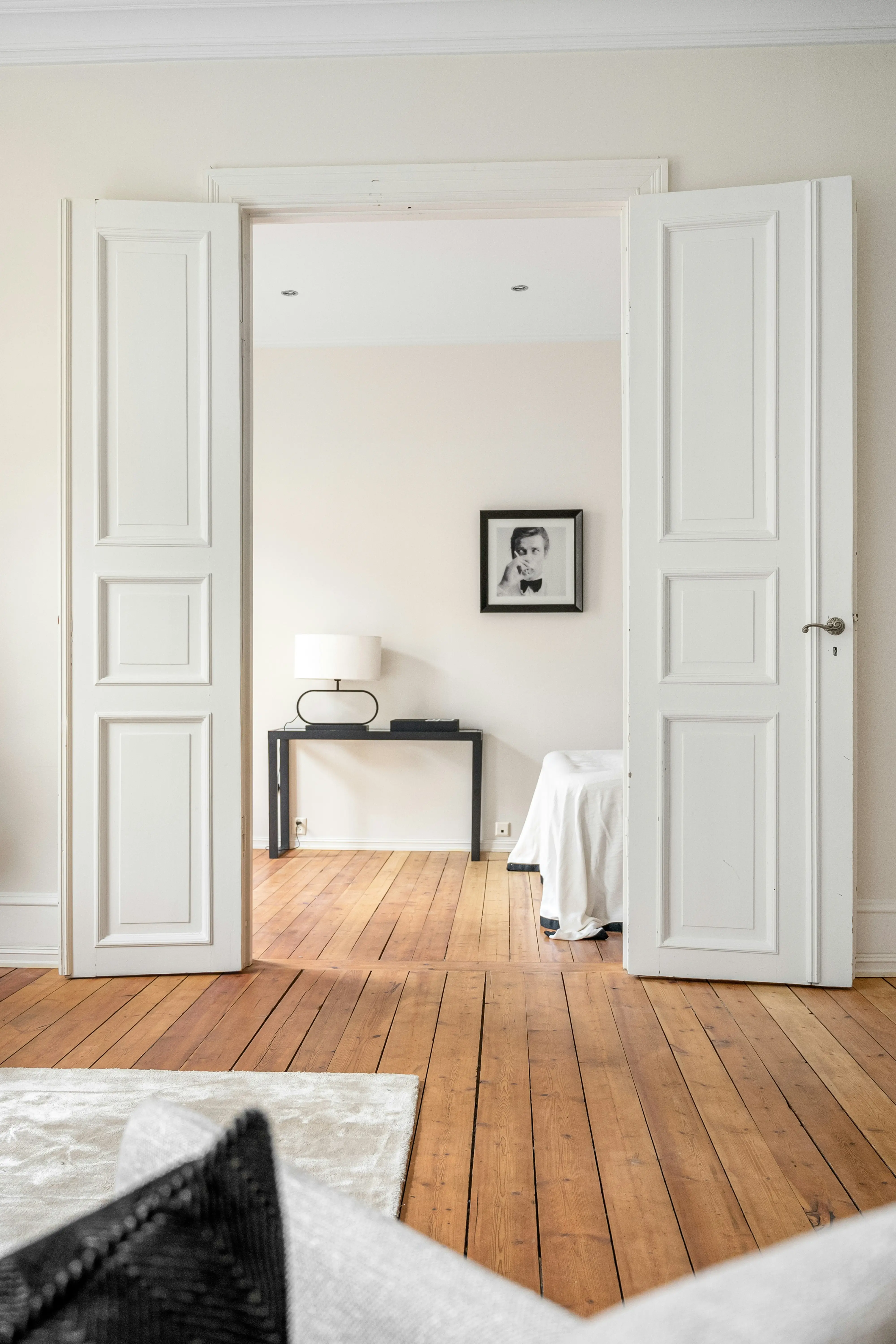 A bright room featuring wooden floors and white walls, creating a clean and spacious atmosphere.