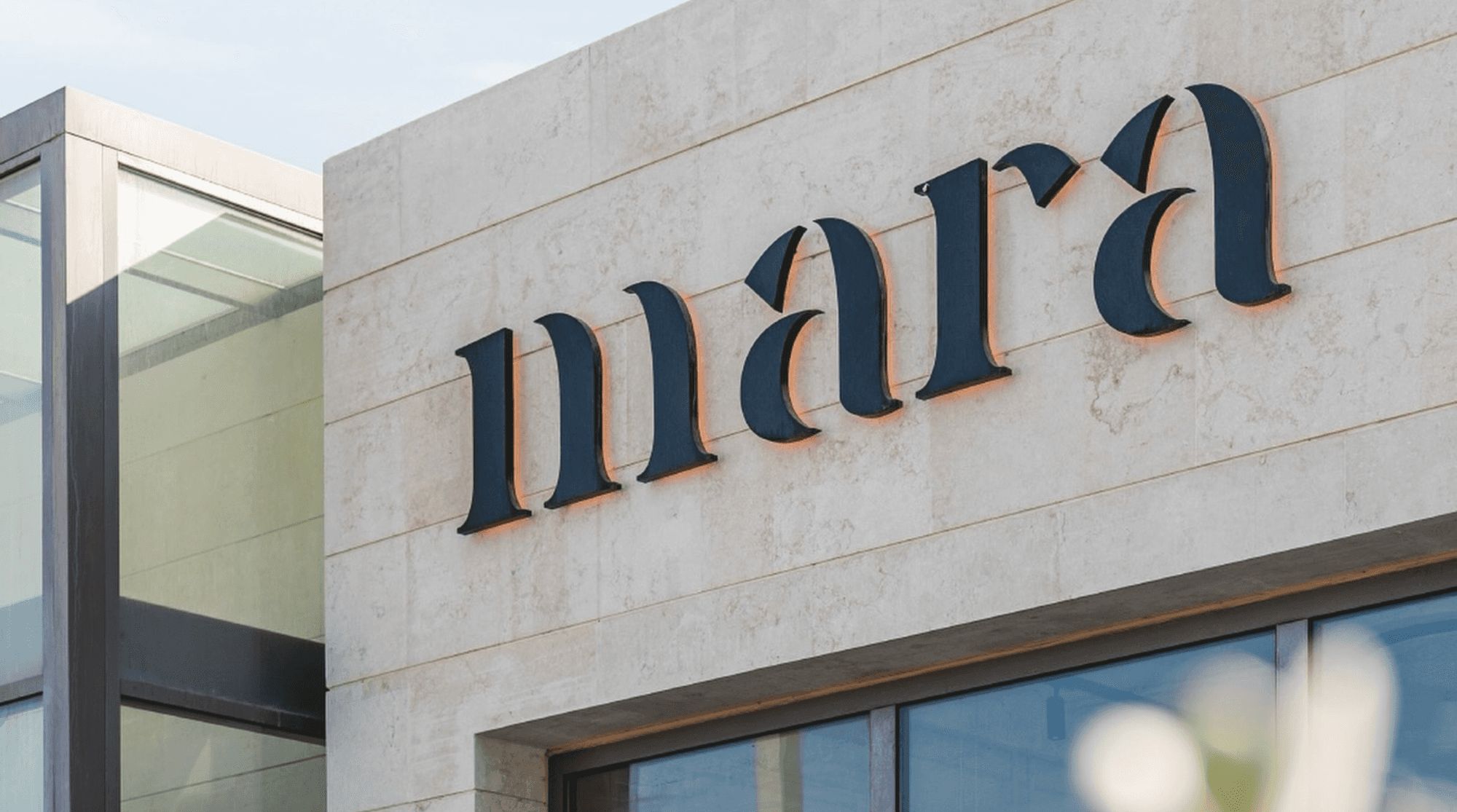Mara Lounge Restaurant in Dubai with a large sign placed on the beige, tiled exterior.
