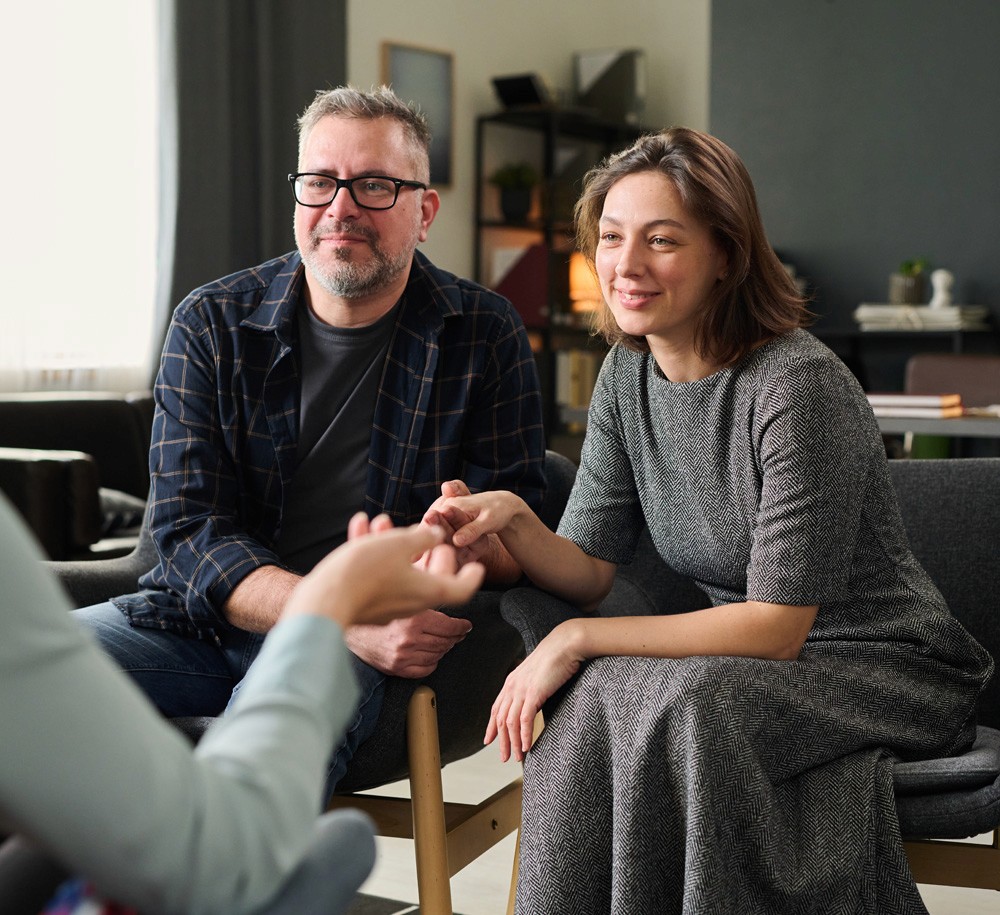 husband and wife talking to medical professional