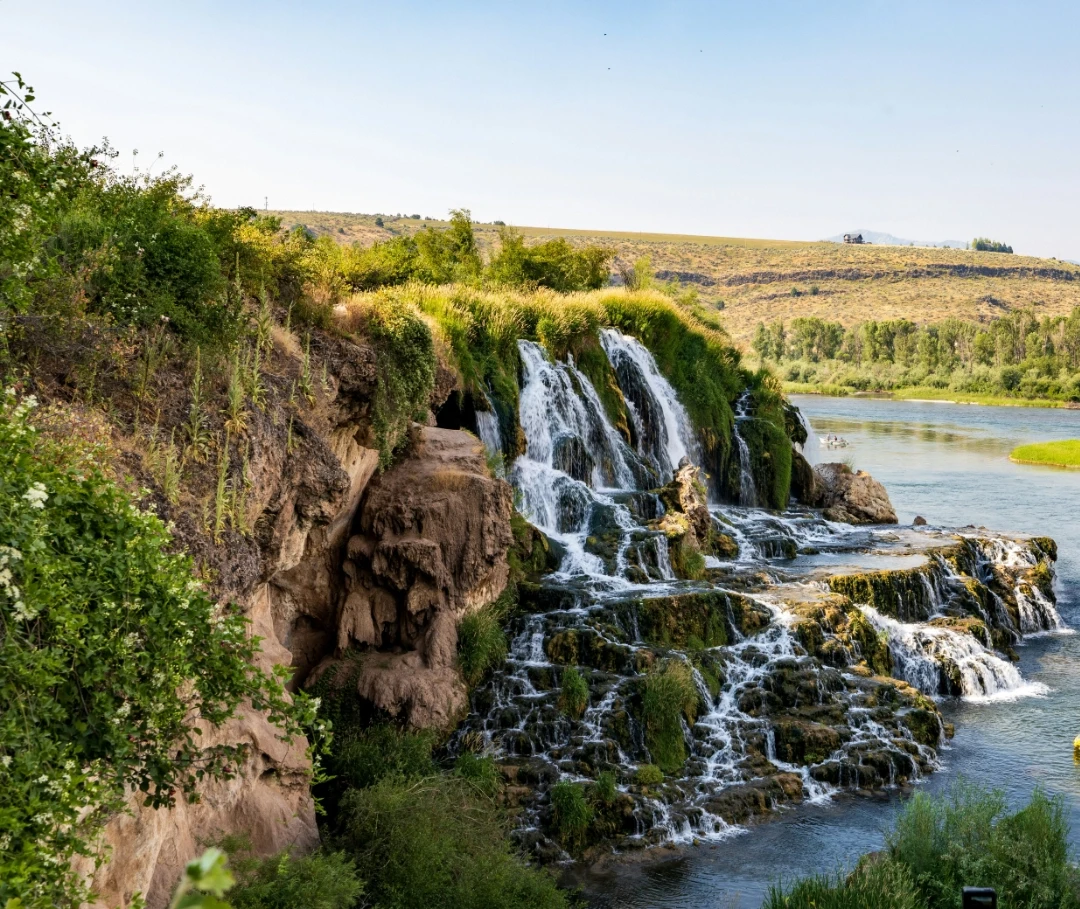 Idaho Falls with people boating in the distance.