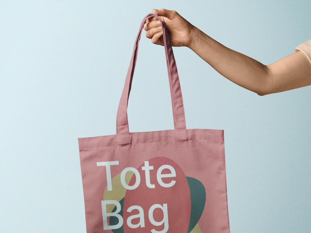 Tote bag mockup holded by a hand