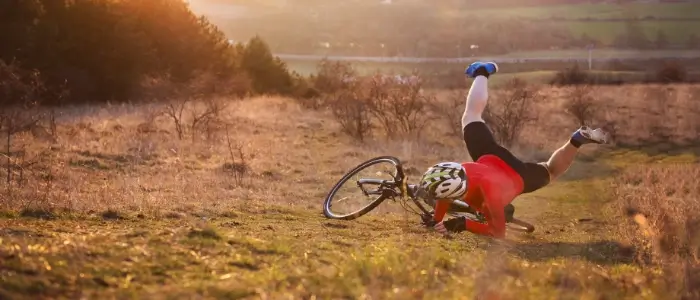 man falling off his bike in the country