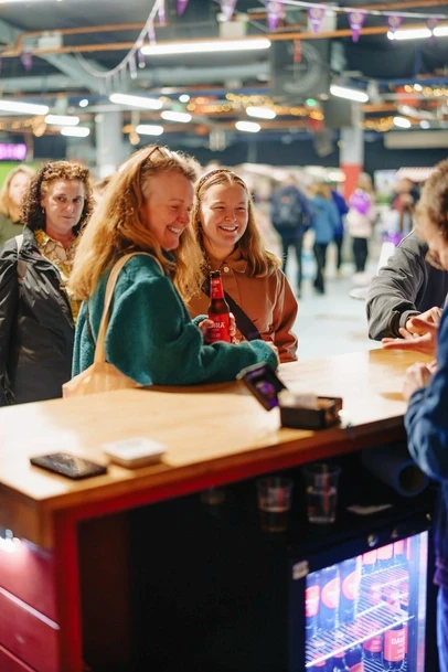 2 women laughing at daura damm beer sale