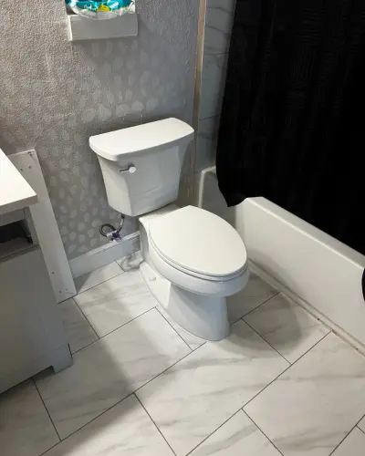 Licensed plumber fixing a clogged residential toilet in Arlington, TX